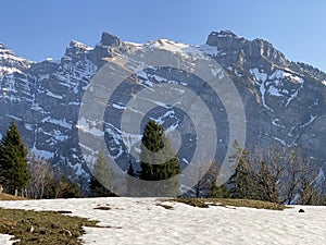 The alpine mountain range GlÃ¤rnisch in the Swiss massif of Glarus alps and over the KlÃ¶ntalersee reservoir lake