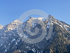 The alpine mountain range GlÃ¤rnisch in the Swiss massif of Glarus alps and over the KlÃ¶ntalersee reservoir lake