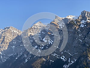 The alpine mountain range GlÃ¤rnisch in the Swiss massif of Glarus alps and over the KlÃ¶ntalersee reservoir lake