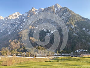 The alpine mountain range GlÃ¤rnisch in the Swiss massif of Glarus alps and over the KlÃ¶ntalersee reservoir lake