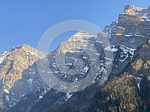 The alpine mountain range GlÃ¤rnisch in the Swiss massif of Glarus alps and over the KlÃ¶ntalersee reservoir lake