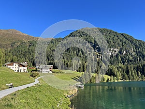 Alpine mountain Seehorn (2238 m) covered with evergreen forest above the tourist and sports mountain lake Davos