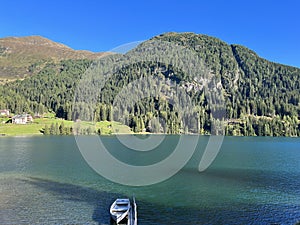 Alpine mountain Seehorn (2238 m) covered with evergreen forest above the tourist and sports mountain lake Davos