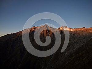 Alpine mountain sunset panorama of Mount Armstrong summit glacier seen from Brewster Hut track Southern Alps New Zealand