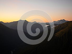 Alpine mountain valley sunset, nature landscape panorama from Brewster Hut West Coast Otago Southern Alps New Zealand