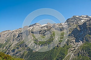 Alpine mountains with forest and granite tops with glaciers , France