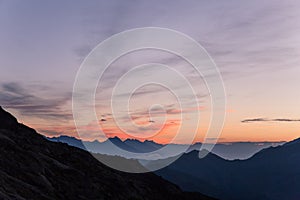 Alpine Mountains Summits at Dawn with Crimson Clear Sky