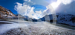 Alpine pass in switzerland, Julierpass in swiss alp with snow and cloudy sky