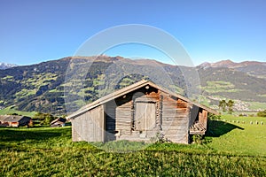 Alpine pasture hike to an old wooden barn with mountain meadow in the austrian alps, Zillertal Austria Europe