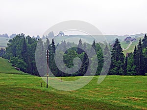 Alpine pastures and mixed forests on the slopes of Hochhamm Mountain and in the UrnÃÂ¤sch Urnaesch or Urnasch river valley photo