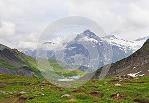 Alpine peaks landskape background. Bachalpsee lake, Grindelwald, Bernese highland. Alps, tourism, journey, hiking