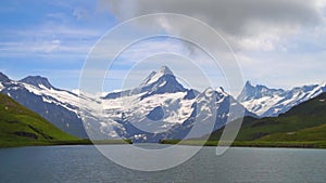 Alpine peaks and mountain lake. Landskape background. Bachalpsee lake, Grindelwald, Bernese highland. Alps, tourism