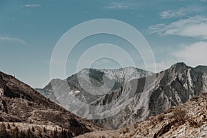 Alpine range on horizon. Structure of rocks with stones on slope. Silhouette of mountain line