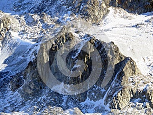 Alpine rock Isla Persa next to the autumn remains of the Vardet da Grialetsch glacier and in the Albula Alps mountain massif photo