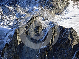 Alpine rock Isla Persa next to the autumn remains of the Vardet da Grialetsch glacier and in the Albula Alps mountain massif photo