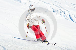 Alpine ski. Skiing woman skier going downhill against snow covered  white ski trail slope piste in winter. Good