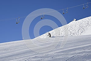 Alpine skier in pisted skisloope