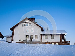 Alpine-style hotel house in the Gornaya Salanga ski resort. The sun rises