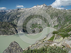 Alpine Swiss valley with big lake and sharp peaks