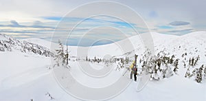 Alpine touring skier hiking in winter mountains.