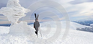 Alpine touring skier in winter mountains.