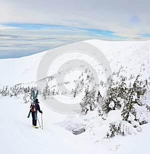 Alpine touring skier in winter mountains.