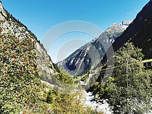Alpine valley and river sorounded by mountains