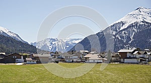 Alpine village road in the Austrian Alps - Stock Photo