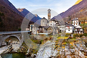 Alpine village of Lavertezzo on rocky slopes of mountain river Verzasca in winter, Switzerland