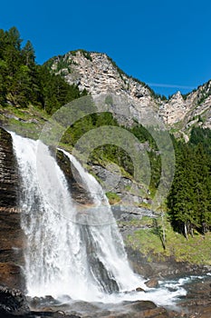 Alpine waterfall in mountain forest