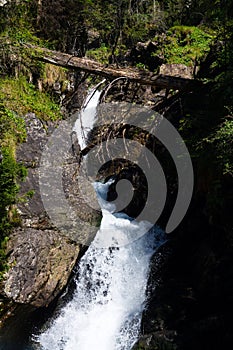 Alpine waterfall Riesachwasserfall from lake Riesachsee near Schladming in Austria