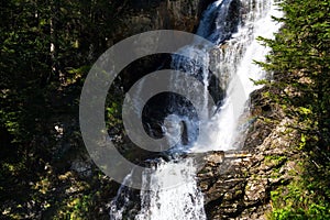 Alpine waterfall Riesachwasserfall from lake Riesachsee near Schladming in Austria