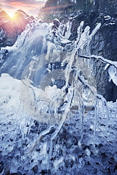 Alpine waterfall in winter