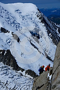 Alpinist climbing Aiguille du Midi at 3842m, Mont Blanc massif