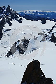 Alpinist climbing Aiguille du Midi at 3842m, Mont Blanc massif