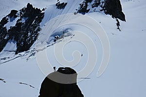 Alpinist climbing Aiguille du Midi at 3842m, Mont Blanc massif