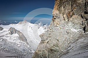 Alpinist climbing  Dent du Geant cliff, mountains landscape view