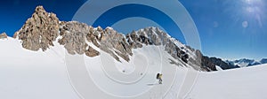 Alpinist climbing high mountain peaks snow and ice panorama landscape