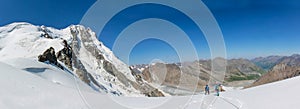 Alpinist climbing high mountain peaks snow and ice panorama landscape