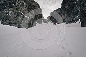 An alpinist climbing in winter alpine like landscape of High Tatras