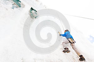 Alpinist guy climbing training ice glacier wall Andes Peru