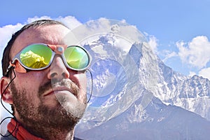 Alpinist looking at summit, mountain background