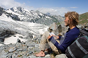 Alpinist looking to map in wild mountains photo