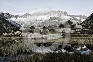 Alpinist makes a break during a sunrise at a mountain lake in the alps