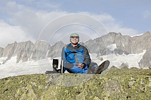 Alpinist makes a tea break before breathtaking mountain views