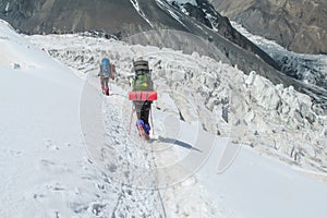 Alpinist on summit of Ibn Sina, Avicenna or Lenin Peak