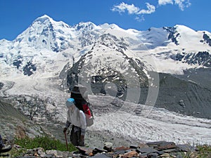 Alpinist tourist with big backpack in Caucasian mountains, near Tetnuldi