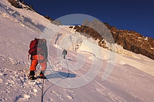 Alpinists ascending to the top of Mont Maudit mount Mont Blanc massif in French Alps, Chamonix Mont-Blanc, France. Scenic image of