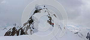 Alpinists climbing high mountain peaks snow and ice panorama landscape