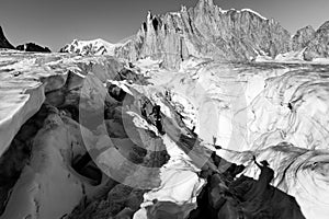 Alpinists crossing glacier crevasse, Aiguilles du Diable peak, Mont Blanc